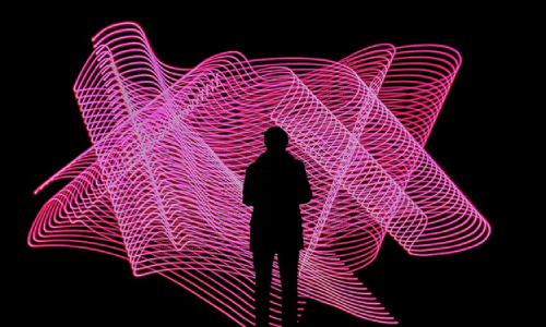 Dark human shadow in front of convoluted pink figure