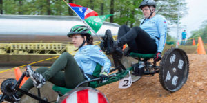 Two People Riding Recumbent Bicycles on Dirt