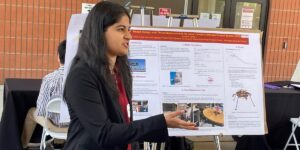 Woman in Suit in front of Poter Explaining