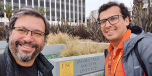 Two people taking selfie outside ISI Marina del Rey towers