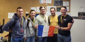 Group of five people holding the French flag