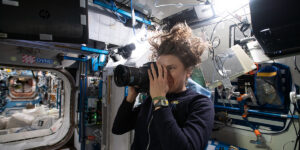 Person inside the international space station taking a photo