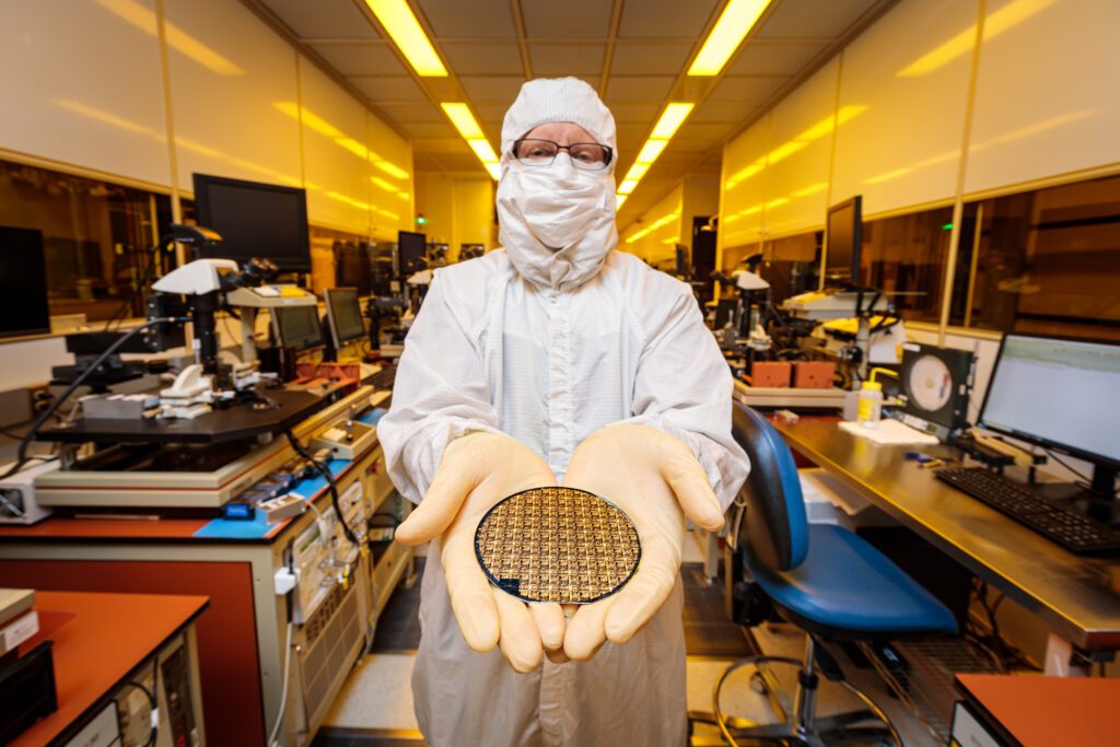 Photo of researcher holding semiconductor wafer