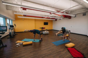 Yoga room with people practicing yoga