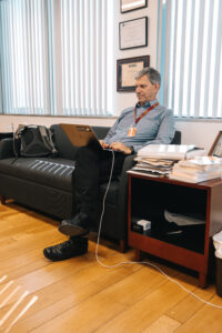 Worked seated on office couch working on computer