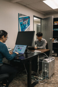 Researchers working on computer across the desk