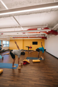 Yoga room with people practicing yoga