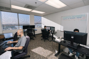 Office space with open concept and multiple people working on computers