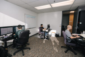 Office space with open concept and multiple people working on computers